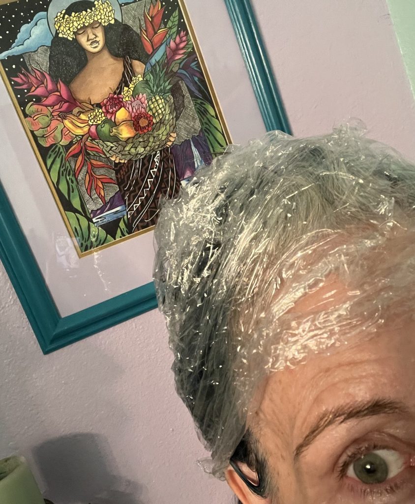 Michelle with plastic wrap covering her hair while waiting for blue dye to process during a playful hair-color experiment.